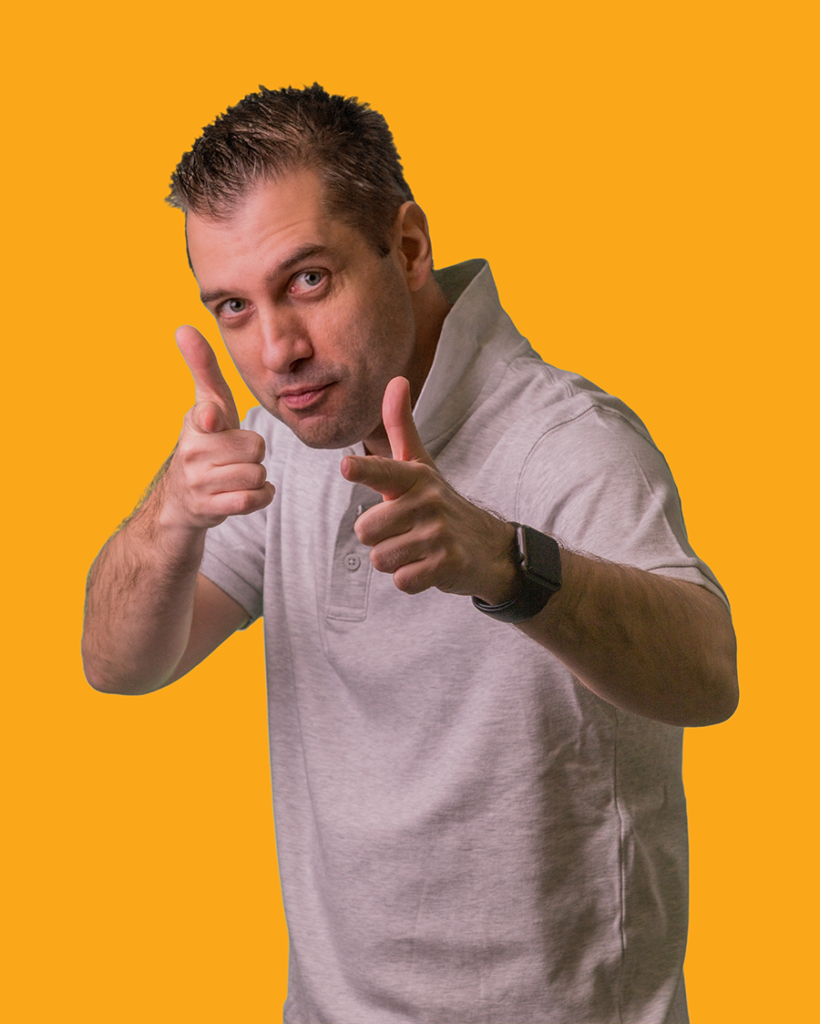 tibor smiling corporate photo with yellow background pointing at you